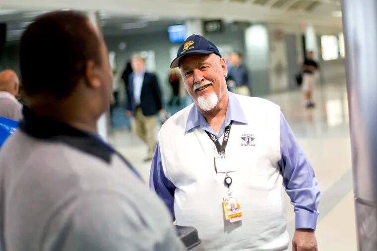 The Rev. Frank Colladay Jr., right, talks with airport worker Lance Norris as he makes his rounds through a concourse at Hartsfield-Jackson International Airport, in Atlanta.