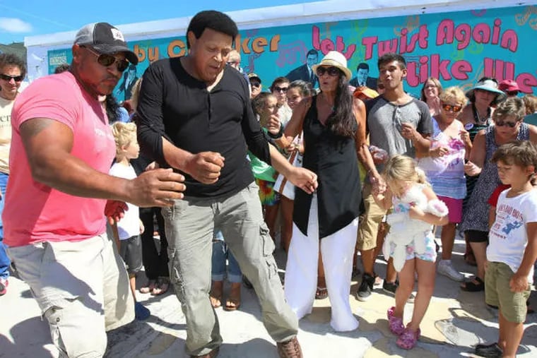 Chubby Checker dancing to &quot;The Twist&quot; on Monday in front of a newly unveiled Wildwood mural of the singer. Checker first performed the hit song live in Wildwood in 1960. (TOM BRIGLIA / For The Inquirer)