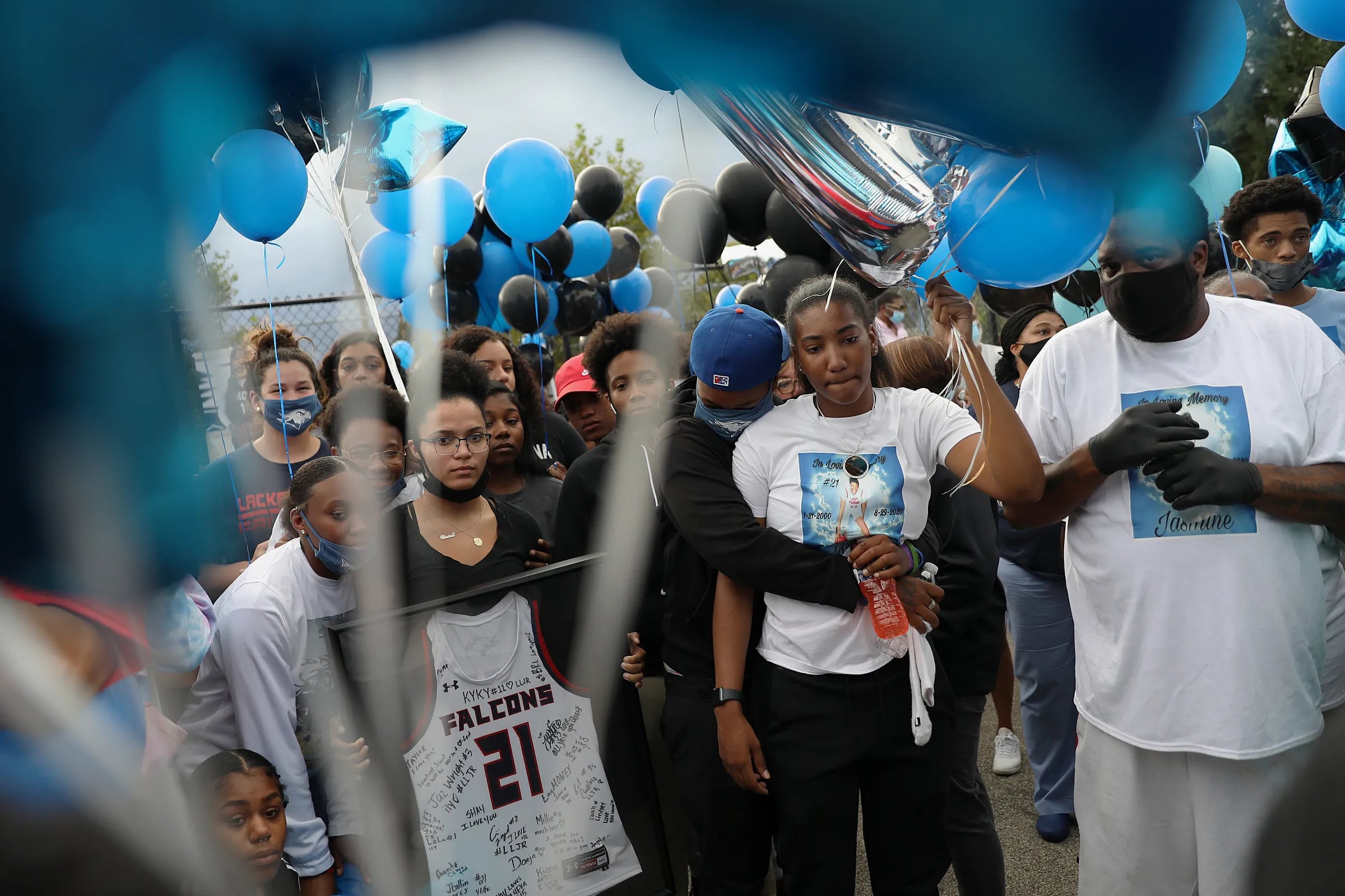 Jaylah Robinson (second from right) holding balloons at the start of a vigil for her sister Jasmine Lewis at Sturgis Playground in Philadelphia's Oak Lane section on Sept. 1, 2020. 