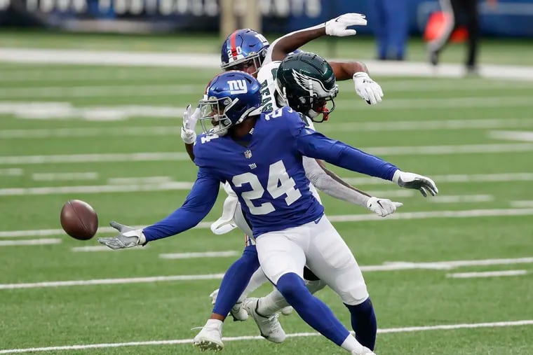 Eagles wide receiver Jalen Reagor getting defended by New York Giants cornerback James Bradberry (24) and free safety Julian Love during the second quarter on Nov. 15, 2020.
