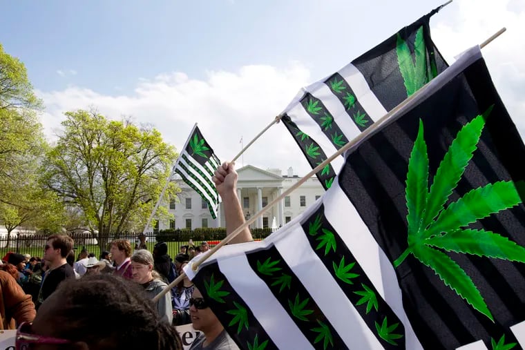 A demonstrator waves a flag with marijuana leaves depicted on it during a protest calling for the legalization of marijuana, outside of the White House on in 2016.