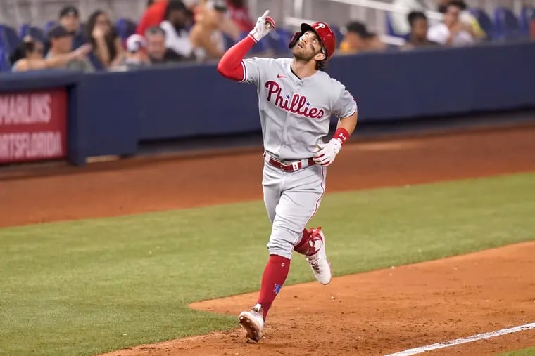 Bryce Harper rounds the bases after hitting a solo home run during the fifth inning of Friday night's game in Miami. The victory clinched the Phillies' first winning season since 2011, but it means little when the club is missing the playoffs yet again.