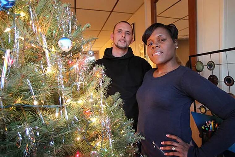 Erica Forston (right) with Frank Shipley inside Shipley's Kensington home on Thursday, December 12, 2013.  Erica Forston says she'll never really be able to thank the Good Samaritans who helped her when her car was stolen with her baby inside. Shipley used his car, which he needs for work, to block the carjacker from getting away.  (Yong Kim / Staff Photographer)