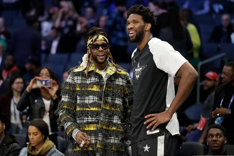 Joel Embiid speaks with Rapper 2 Chainz before the NBA All-Star basketball game, probably not about anti-inflammatory solutions for sore left knees.