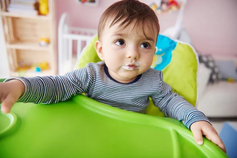 Close up of little boy sitting on the high chair