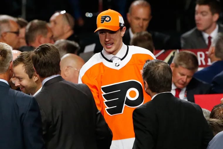 Isaac Ratcliffe talks with representatives from the Flyers after the team traded up to select him in the secround round of the NHL hockey draft.