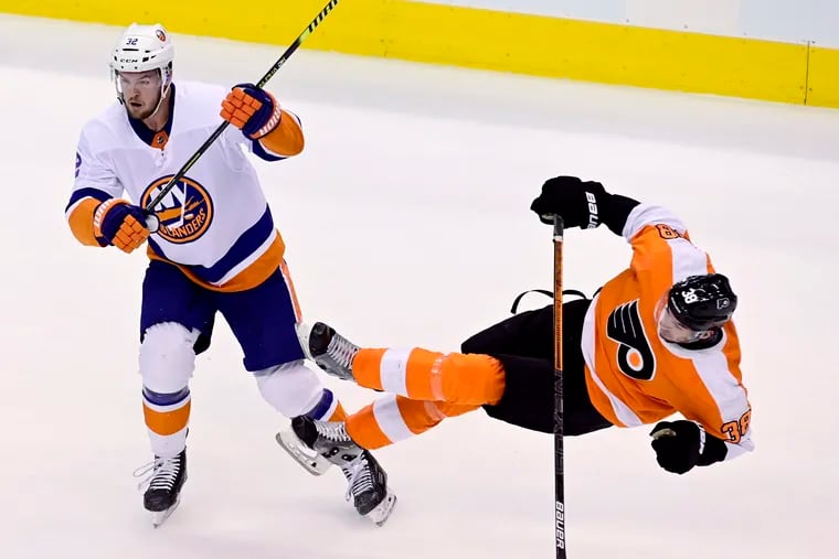 Islanders defenseman Adam Pelech levels Derek Grant during the first period of Monday night's series opener. The Islanders controlled play in the first and went on to a 4-0 win.