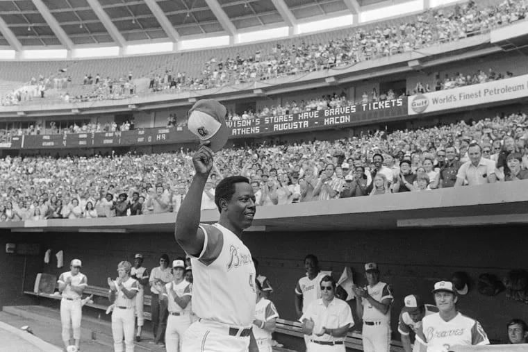 Hank Aaron of the Atlanta Braves reacts after hitting his 700th career home run against the Philadelphia Phillies on July 21, 1973, in Atlanta.