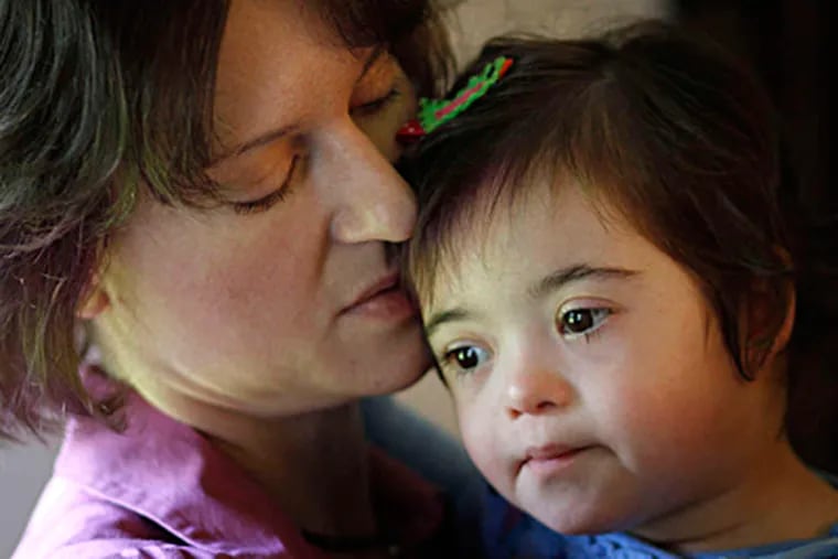 Susanna Musser holds Katie. When the Mussers of Lancaster County adopted Katie, a child with Down syndrome, from an orphanage, she was less than 11 pounds - and 9 years old. MICHAEL S. WIRTZ / Staff Photographer