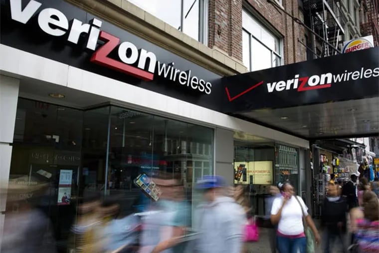 FILE - In this June 6, 2013, file photo, pedestrians pass a Verizon Wireless store on Canal Street in New York. Verizon reports quarterly earnings on Thursday, Oct. 17, 2013. (AP Photo/John Minchillo, File)