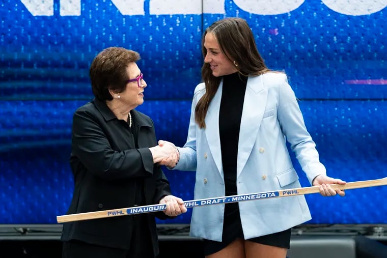 Taylor Heise (right) shakes hands with tennis legend Billie Jean King after being selected first overall by Minnesota in the inaugural Professional Women's Hockey League draft on Sept. 8 in Toronto.