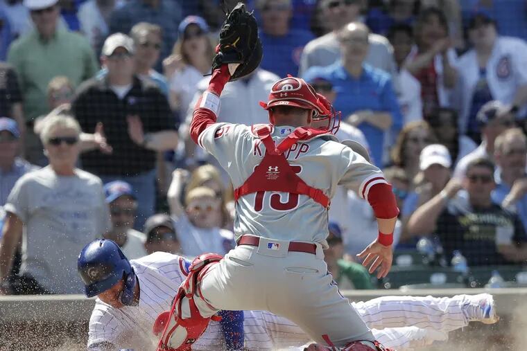 Phillies catcher Andrew Knapp tries to lay the tag down on Albert Almora Jr. in the fifth inning of the Phillies 4-3 loss to the Cubs. The play was overturned by video review with Knapp called for catcher interference. 