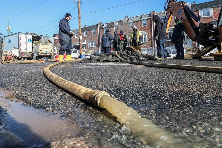 Philadelphia Water Department workers respond to a water main break in January in Northeast Philadelphia. As part of its rate increase request, the department wants to ramp up replacing the city’s aging water mains.