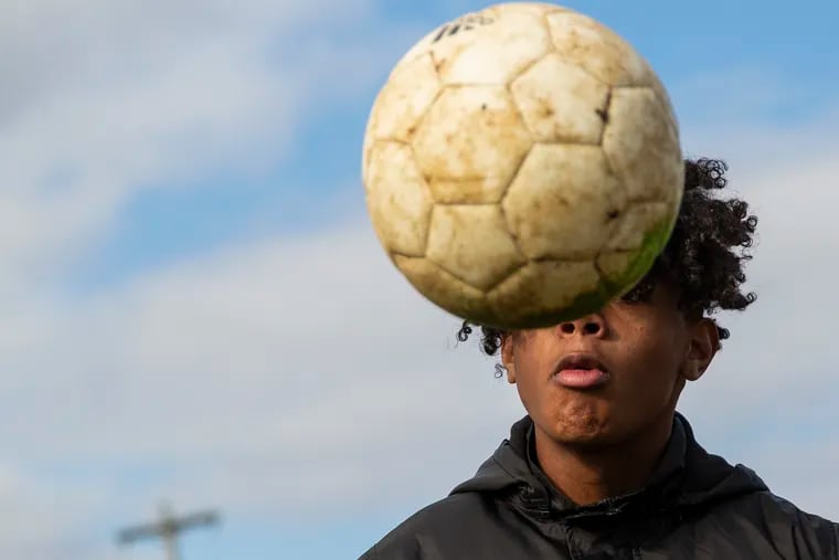 Julio Reyes, 16, dribbles the ball off his head at the Kensington Soccer Club field at 3rd and Dauphin.