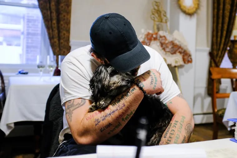 Michael McDaniel, 38, holds his mom's dog Loki, 5. Michael was diagnosed with schizophrenia in 2007. The McDaniel family has been working and caring for Michael to bring awareness to his illness.