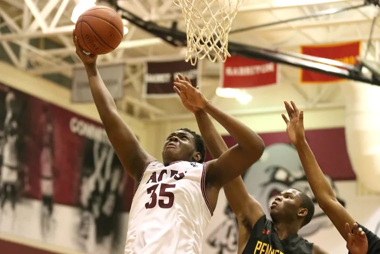 Demetrius Lilley of Lower Merion shoots over Denzel Quinn of Penncrest in a key Central League boys' basketball game. Lilley scored 18 as Lower Merion won, 64-40.