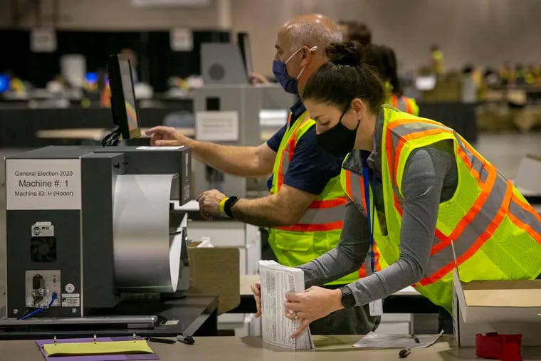 Philadelphia election workers count mail ballots at the Pennsylvania Convention Center in 2020. The process took days that year.
