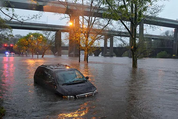 A mini van stalled on Kelly Drive near Midvale due to Schuylkill flooding.   (RON TARVER / Staff Photographer ) April 30 2014