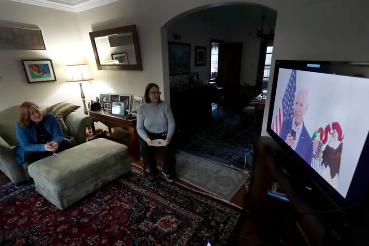 Lally Doerrer, right, and Katharine Hildebrand watch Joe Biden during his Illinois virtual town hall, in Doerrer's living room on Friday.