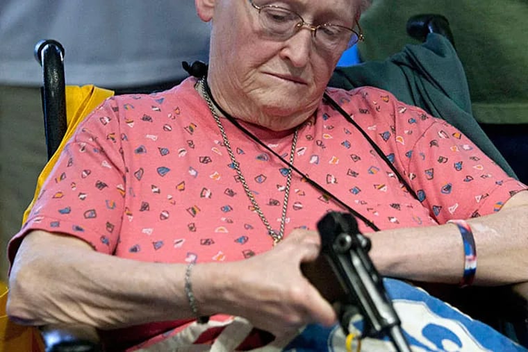 At the NRA convention, Janet Bero waits to have her German Luger appraised. The three-day event in Houston includes gun trade show, political rally, and strategy meeting. JOHNNY HANSON / Houston Chronicle