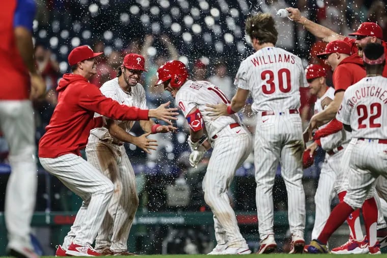 Phillies catcher J.T. Realmuto (10) celebrates with teammates after his walk-off, two-run triple beat the Orioles in the 10th inning at Citizens Bank Park.