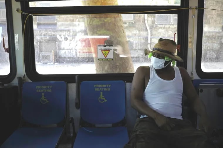 A man sits in a Septa Cooling Bus along Allegheny Avenue and Germantown Avenue during a heat wave last summer. Cooling buses are part of the city's lauded heat-response plan.