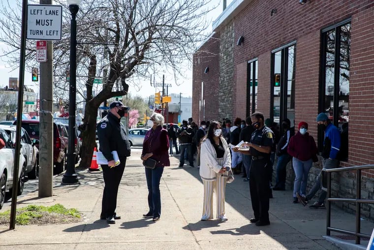 People wait outside of a neighborhood vaccine clinic in a multipurpose building on Ogontz Avenue in the West Oak Lane section of Philadelphia on March 29, 2021. This is the ninth city-run mass vaccine clinic to open.