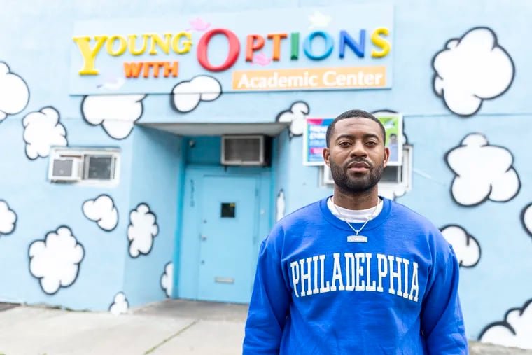 Dappa Samuels, rapper and owner of Young With Options Academic Center, poses for a portrait in front of his day care in West Philadelphia, Pa., on Thursday, July 20, 2023.