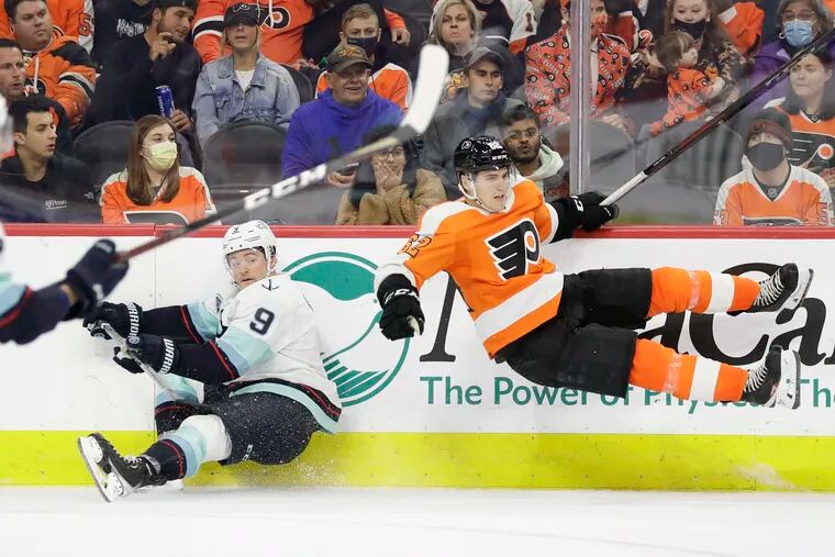 Flyers' right wing Nicolas Aube-Kubel gets up-ended after checking Seattle's Kraken center Ryan Donato during the third period on Monday.