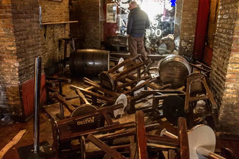 Overturned tables and stools are seen inside "The Drunken Ship" pub in Rome's central Campo dei Fiori square, Thursday, Nov. 22, 2012. Dozens of suspected Lazio soccer  fans wielding cobblestones, knives and metal rods attacked Tottenham supporters out drinking ahead of their Europa League match, stabbing at least one and sending seven of them to the hospital, police and witnesses said.  Rome police say they detained some of the 50 hoodlums but others got away early Thursday after trashing the pub in Rome's Campo de' Fiori square, a popular drinking spot. Blood stained the cobblestones outside the bar, and stools and tables were overturned. (AP Photo/Angelo Carconi)
