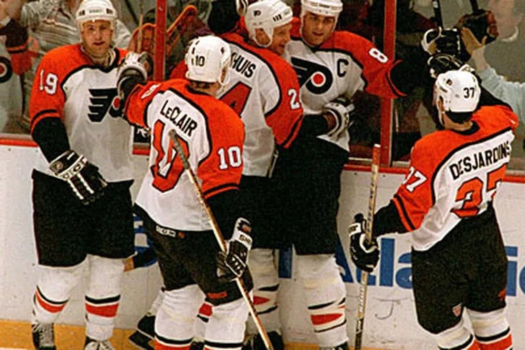 Former Flyers Eric Lindros (8), John LeClair (10) and Eric Desjardins (37) will play in the alumni game. (File Photo)