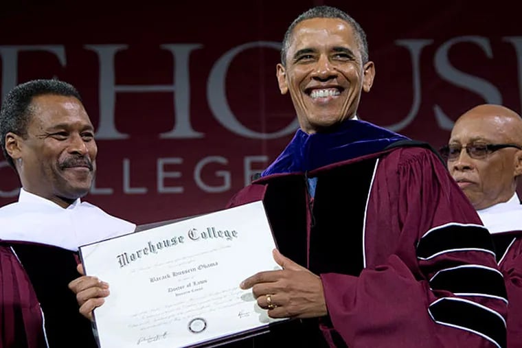 At Morehouse College, President Obama holds his honorary doctorate of laws, flanked by college president John Silvanus Wilson Jr. (left) and Robert Davidson, board of trustees chairman. (Carolyn Kaster/AP)