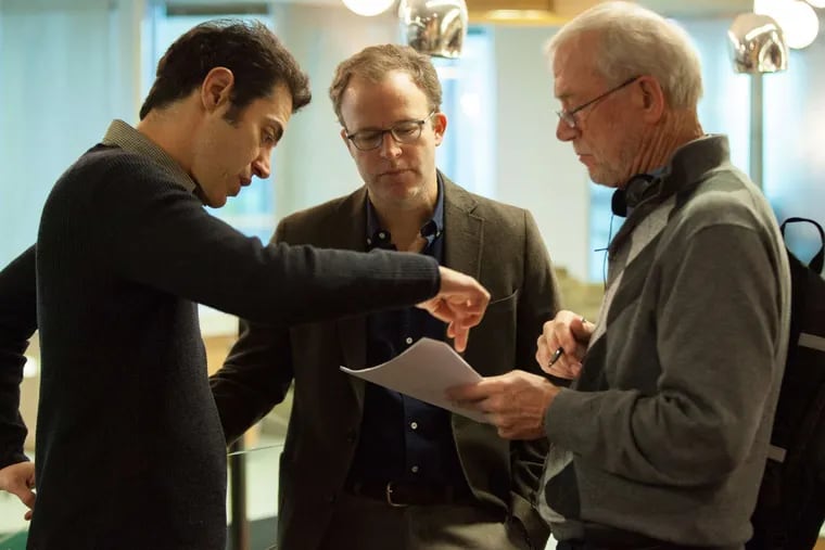 On the set of 'Spotlight,'  about the Boston Globe investigation of pedophile priests, (from left) writer Josh Singer, co-writer/director Tom McCarthy, and Globe editor Walter Robinson confer.