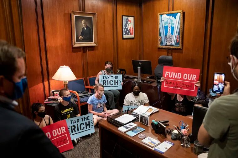 Mayor Jim Kenney's chief of staff Jim Engler, left, listens as protesters with Reclaim Philadelphia stage a sit-in in the mayor's office.