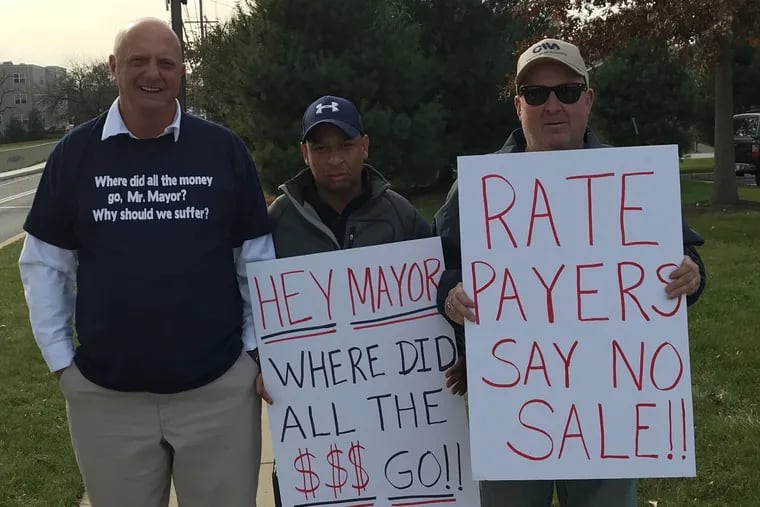 Joe Stafford of Upper Chichester (left), Bill Barber of Chester (center), and Ron Navin Upper Chichester protest outside before a meeting of the Chester Water Authority board, which is split among members from Chester City, Delaware County, and Chester County on Nov. 21, 2017.