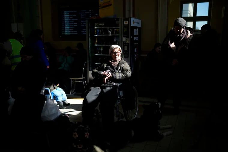 Ukrainian refugees wait at Przemysl train station, southeastern Poland, on Friday, March 11, 2022. Thousands of people have been killed and more than 2.3 million have fled the country since Russian troops crossed into Ukraine on Feb. 24.