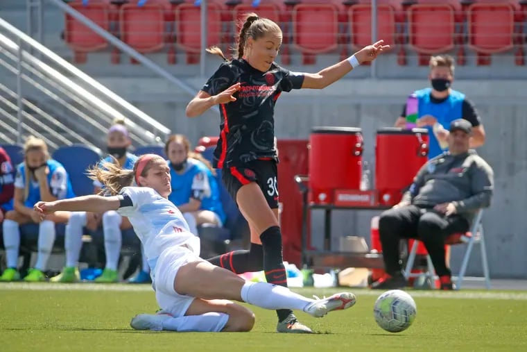 Chicago Red Stars defender Kayla Sharples slides to tackle the ball away from Portland Thorns midfielder Celeste Boureille (30) during the first half.