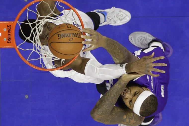 Kings' DeMarcus Cousins, right, dunks the ball against Sixers' Nerlens Noel during the first half.