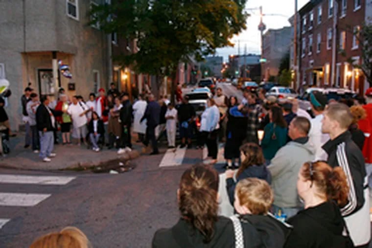 Family and friends form a circle outside the house at Masters and Hancock Streets where Miller&#0039;s body was found in a plastic tub.