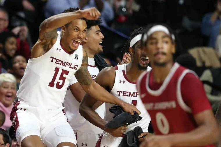 Temple teammates (from left) Nate Pierre-Louis, Jake Forrester, and Quinton Rose celebrating near the end of their victory over St. Joseph’s on Tuesday.