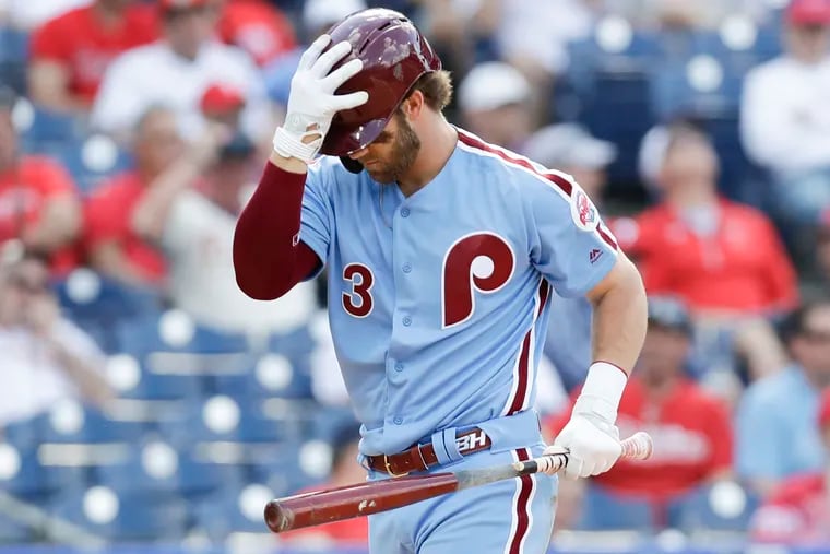 Phillies Bryce Harper touches his batting helmet after striking swinging in the eighth-inning against the Milwaukee Brewers on Thursday, May 16, 2019 in Philadelphia.