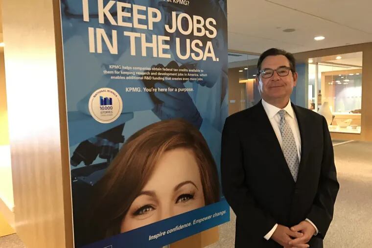 Bruce N. Pfau, who until 2016, was KPMG’s vice chairman in charge of Human Resources, in front of a poster produced as part of KPMG’s 10,000 Story Challenge. The goal  was to boost employee satisfaction and retention by connecting auditors and accountants with the higher purpose of their work.