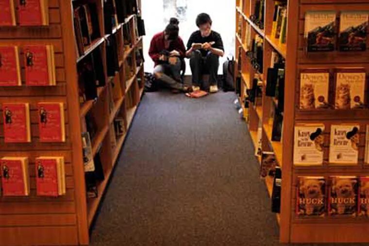 Customers read books in the stacks at the Borders Book Store at the corner of Broad and Chestnut on Friday afternoon, March 18, 2011. (Laurence Kesterson / Staff Photographer)