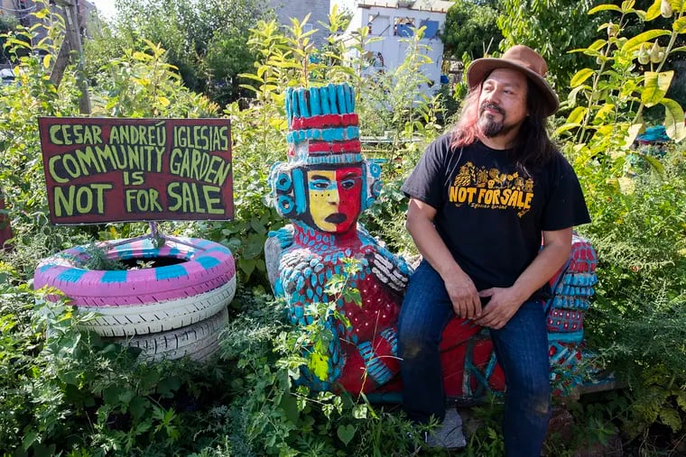 For 10 years, West Kensington's Iglesias Garden has provided a space for neighbors to connect with each other, nature, and their Latino cultures. Now, they're demanding the city keep other vacant lots away from developers and leave them for communities instead. Cesar Viveros, one of the founders of the garden, sits by one of the statues that serves as guardians of the garden.