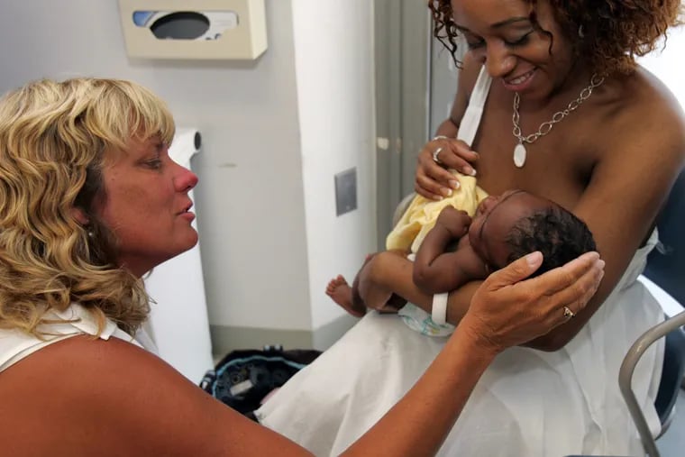 Diane Spatz helps Toyya Wills nurse her son during their 2007 visit to a pediatric clinic at Children's Hospital of Philadelphia. Spatz is leading a study at the clinic to see if support for nursing mothers will prompt them to nurse their children longer. Women in Philadelphia breast-feed their children at a lower rate than other major cities