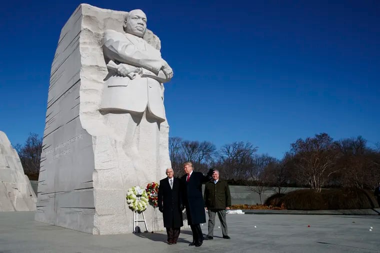 Donald Trump and Mike Pence, left, escorted by then-Acting Interior Secretary David Bernhardt, rear, walk off after visiting the Martin Luther King Jr. Memorial, Monday, Jan. 21, 2019, in Washington.