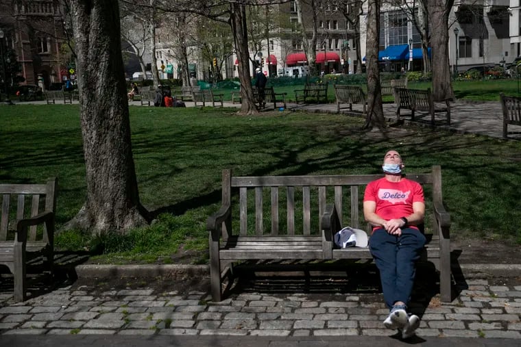 A man lounges in Rittenhouse Square Park in Philadelphia on April 8.