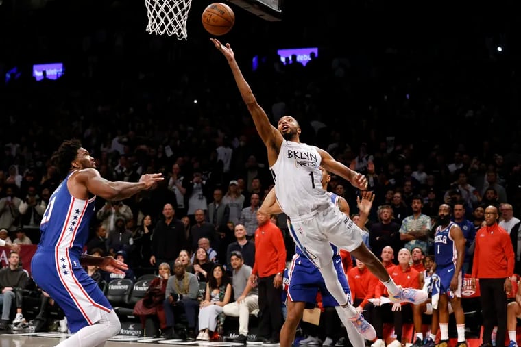 Brooklyn Nets' Mikal Bridges goes to the basket against 76ers' Joel Embiid on Feb. 11 in New York.