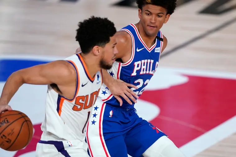 Suns guard Devin Booker tries to get past 76ers guard Matisse Thybulle (22) during the second half of Monday's game.