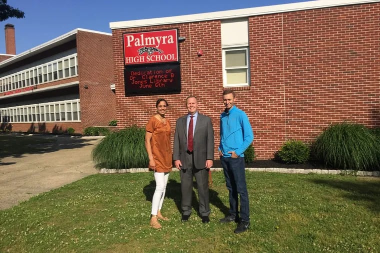 From left, Valerie Still, Brian McBride and Dan Licata stand outside Palmyra High School. The three collaborated to bring Clarence Jones, a civil rights icon and Palmyra alumnus, back to the school.